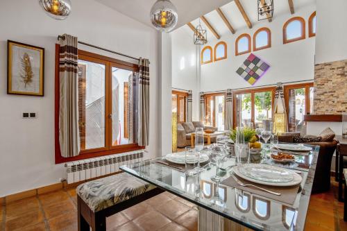 a dining room with a table with dishes on it at 7 bedroom Villa for 15 ppl Heated pool, sauna, hot tub on El Valle Golf, Murcia 