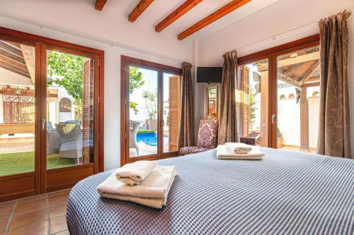 a bedroom with a bed with towels on it at 7 bedroom Villa for 15 ppl Heated pool, sauna, hot tub on El Valle Golf, Murcia 