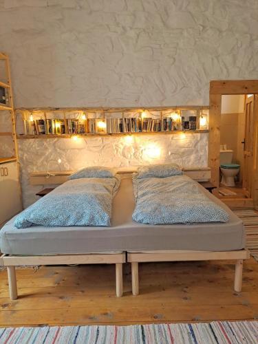 a bed with two pillows on it in a room at Casa Petri Rosia Montana in Roşia Montană