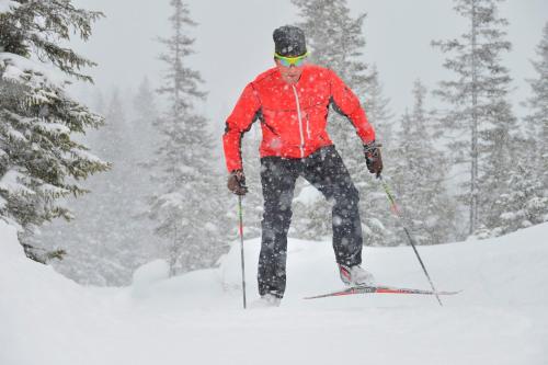 a man is skiing down a snow covered slope at Hotel Arlmont 4 Stern Superior in Sankt Anton am Arlberg