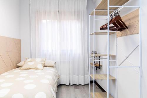 a bedroom with a bed and a book shelf at Castrillo 4 Apartamento Acogedor in Zaragoza