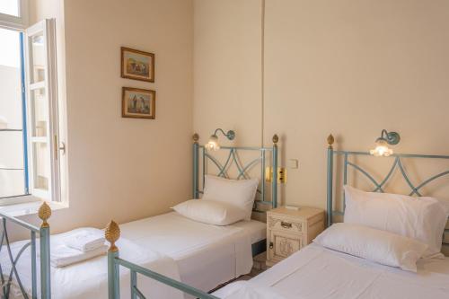 Ένα ή περισσότερα κρεβάτια σε δωμάτιο στο Σουίτες Πανδώρα