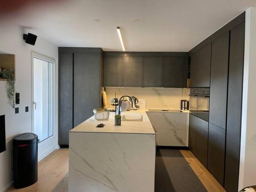 a kitchen with a sink and a counter top at Luxury Mountain Apartment with Private Sauna and Underground Parking in St. Moritz
