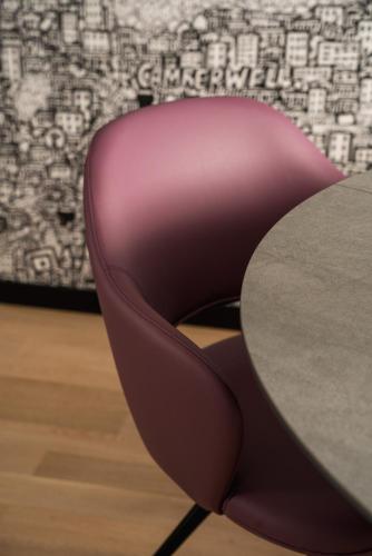 a pink chair sitting next to a table at Mitico Hotel & Natural Spa in Bologna