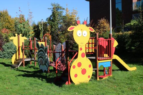 a playground with a giraffe painted on it at Młyn Jacka Hotel & Spa in Wadowice