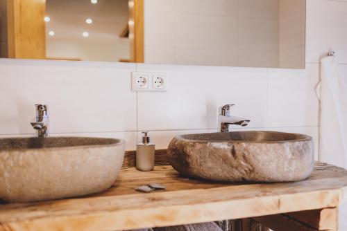 two sinks on a wooden counter in a bathroom at Chalet Molly by we rent in Zell am See