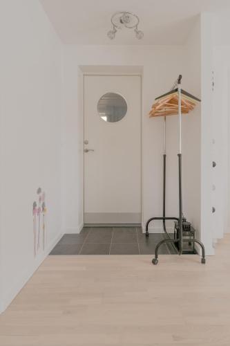 a white room with a white door and a table at Waterfront retreat - 2 BR Boathouse in Oyrareingir