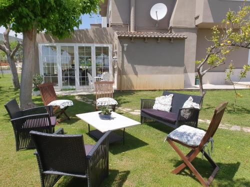 a group of chairs and a table in a yard at Catalunya Casas Close to Salou and just steps from the village! in Alcover