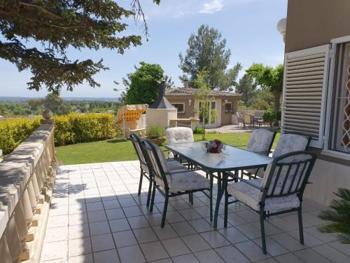 a patio with a table and chairs on a patio at Catalunya Casas Close to Salou and just steps from the village! in Alcover
