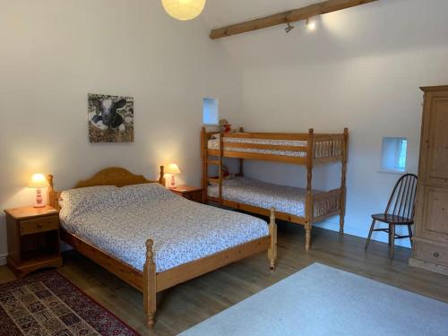 a bedroom with a bunk bed and a chair at The Old Stables, Near Bakewell in Millers Dale