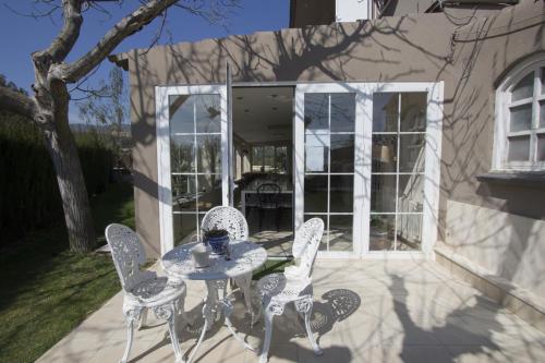 a patio with a table and chairs in front of a house at Catalunya Casas Close to Salou and just steps from the village! in Alcover