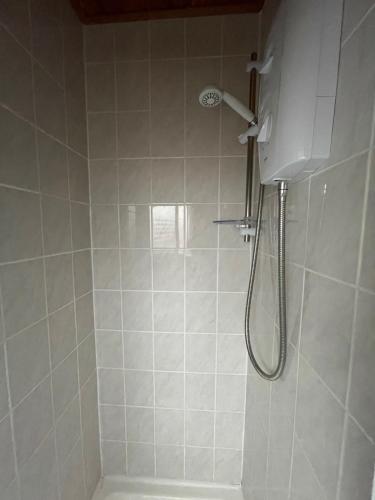 a shower with a shower head in a bathroom at The Sefton Blackpool in Blackpool