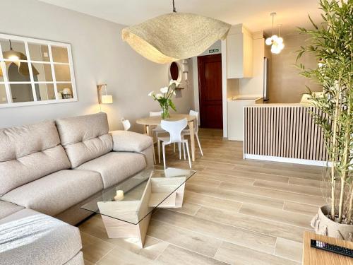 a living room with a couch and a table at Apartamentos Noja Playa in Noja