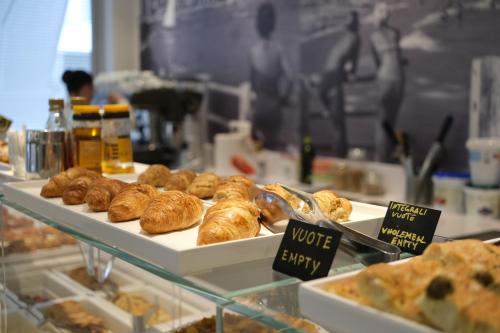 a display case in a bakery with various types of pastries at Hotel Imperiale in Cattolica