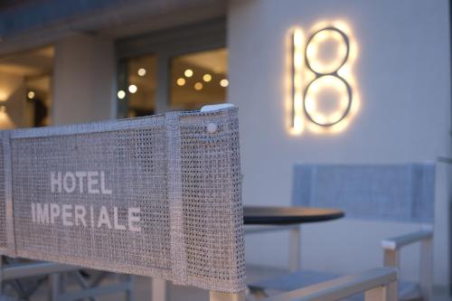 a sign that reads hotel upgrade sitting on a bench at Hotel Imperiale in Cattolica