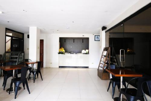 a dining room with tables and chairs and a counter at Palazzo Pensionne in Cebu City
