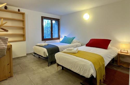 a room with two beds and a window at Wanakaset Pyrénées Orientales in Argelès-sur-Mer