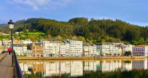 a group of buildings next to a body of water at Camiño Vello 2 in Viveiro