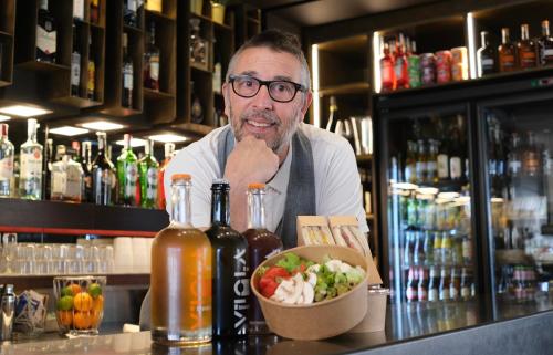 a man standing behind a bar with a bowl of food at Hotel Imperiale in Cattolica