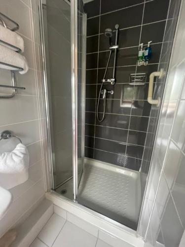 a shower with a glass door in a bathroom at Beechwood House Accommodation in Blarney