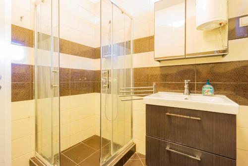 a bathroom with a shower and a sink at Kob Orog good location with sea views and modern decor in Metajna