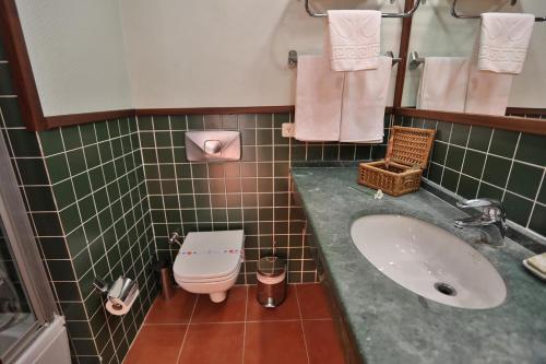 a bathroom with a sink and a toilet at Happy Hotel Kalkan in Kalkan
