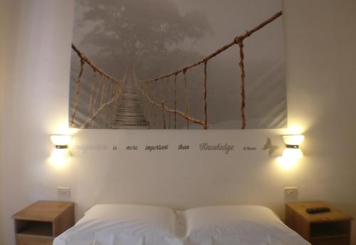 Un ou plusieurs lits dans un hébergement de l'établissement Il Girasole High Quality Inn