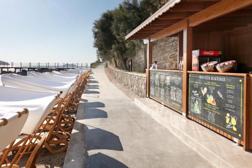 a row of tables and chairs at a seafood restaurant at Xanadu Island in Akyarlar