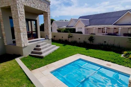 a house with a swimming pool in the yard at Zoete Inval - 3 Bedroom Self Catering Home. in Langebaan