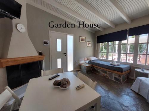 a living room with a table and a garden house at Aggelou Apartments in Spáta