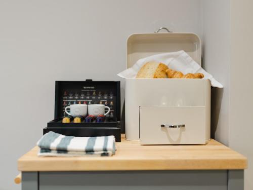 a box of bread sitting on a table next to a toaster at Durham Riverside Apartments in Durham