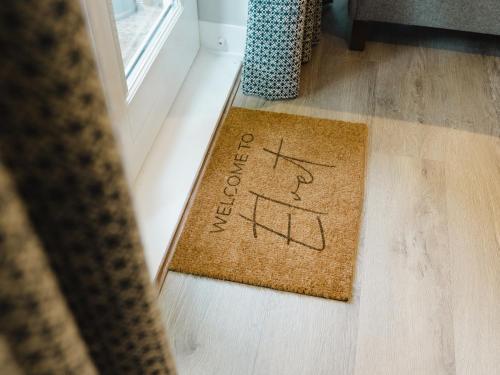 a welcome mat on the floor of a room at Durham Riverside Apartments in Durham