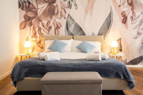 a bedroom with a large bed with a flower mural at Appartamento Anastasia in Verona