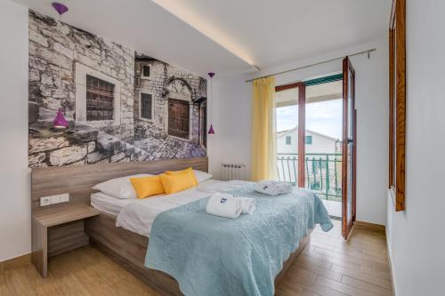 a bedroom with a bed with two towels on it at Apartments G in Trogir