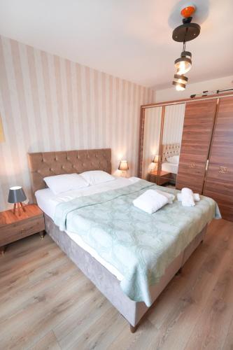 a bedroom with a large bed with two pillows at King Suite SS4 in Istanbul