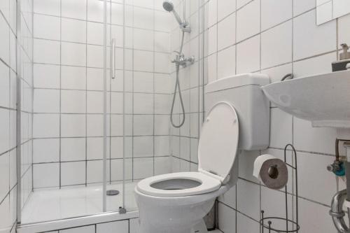 a bathroom with a toilet and a shower and a sink at Budget-Friendly 2BR Apt with Great Location in Vienna