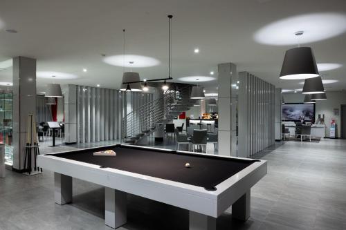 a pool table in a room with a staircase at Vila Gale Collection Monte do Vilar in Albernoa