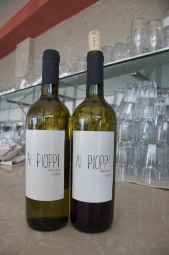 two bottles of wine sitting on a shelf at Villa Pioppi Hotel in Sirmione
