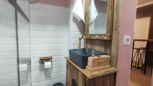 a bathroom with a blue sink and a mirror at Alameda Boho Chic in Seville