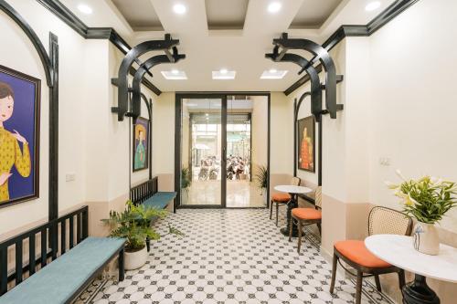 a corridor of a restaurant with tables and chairs at Sun Clover Boutique Hotel in Hanoi
