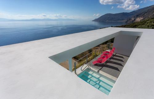 a view of the water from the balcony of a house at Super Luxurious Villa - 600m² - Up to 22 people in Edipsos