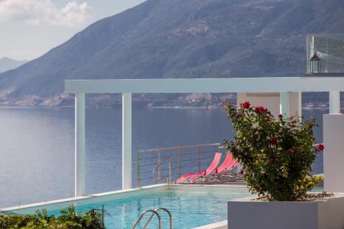 a swimming pool with a view of the water and mountains at Super Luxurious Villa - 600m² - Up to 22 people in Edipsos