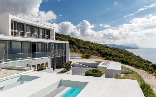 a house with a view of the ocean at Super Luxurious Villa - 600m² - Up to 22 people in Edipsos