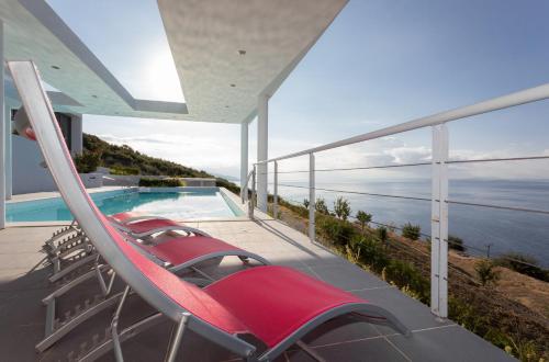 a balcony of a house with a swimming pool at Super Luxurious Villa - 600m² - Up to 22 people in Edipsos