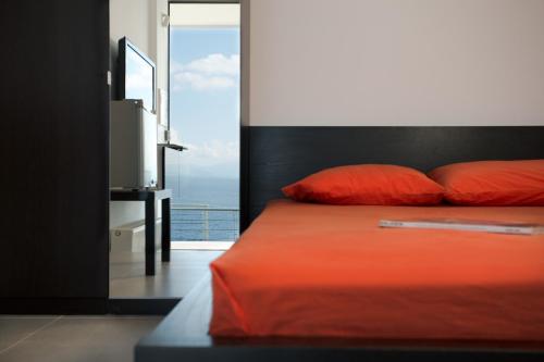 a bedroom with a bed with a view of the ocean at Super Luxurious Villa - 600m² - Up to 22 people in Edipsos