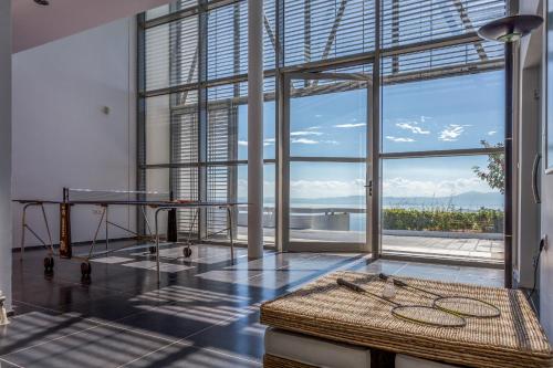 a room with a table and a large window at Super Luxurious Villa - 600m² - Up to 22 people in Edipsos