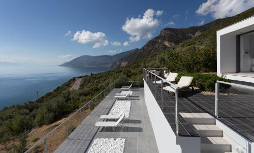 a balcony with a view of the water at Super Luxurious Villa - 600m² - Up to 22 people in Edipsos