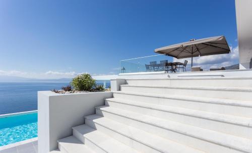 a set of stairs leading up to a house overlooking the water at Super Luxurious Villa - 600m² - Up to 22 people in Edipsos