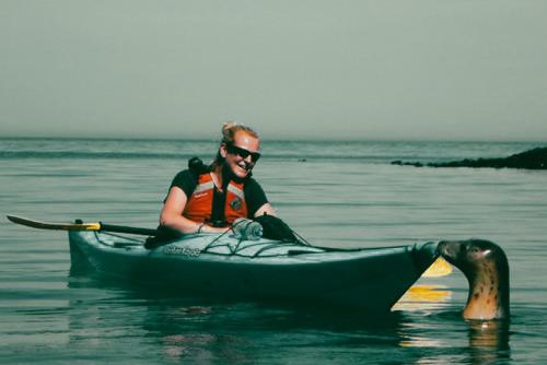 a man sitting in a kayak in the water at Wellies & Waves in Kingsbridge