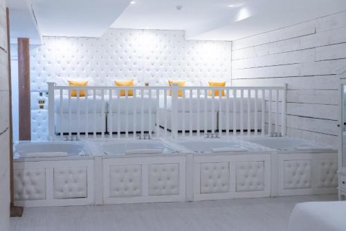 a white room with a bunch of beds in it at The Dixie Dean Hotel in Liverpool